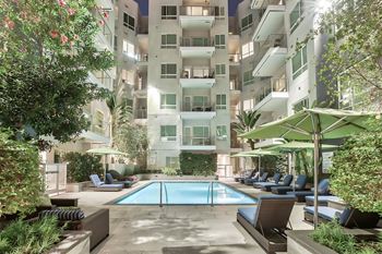 Courtyard with pool at night at Olympic by Windsor, 936 S. Olive St, 90015
